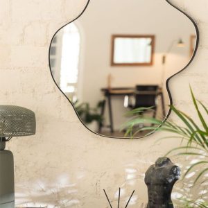 Close-up of shimmering acrylic sliver wall stickers creating a modern and reflective accent wall in a bathroom.