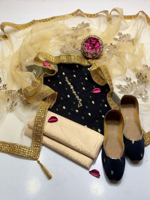 A beautiful South Asian woman in a flowing 4-piece outfit featuring a krinkle chiffon embroidered shirt, net dupatta with mirror work, and mesuri trousers. Perfect for festive occasions!