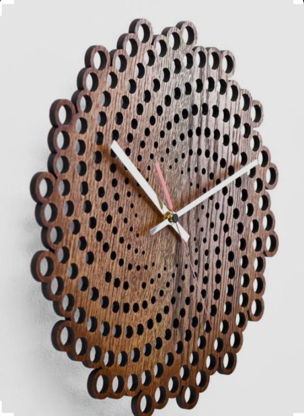A modern spiral wood wall clock hangs on a white wall, casting a soft shadow.