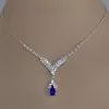 Confident woman wearing a blue gemstone necklace, perfect for a night out