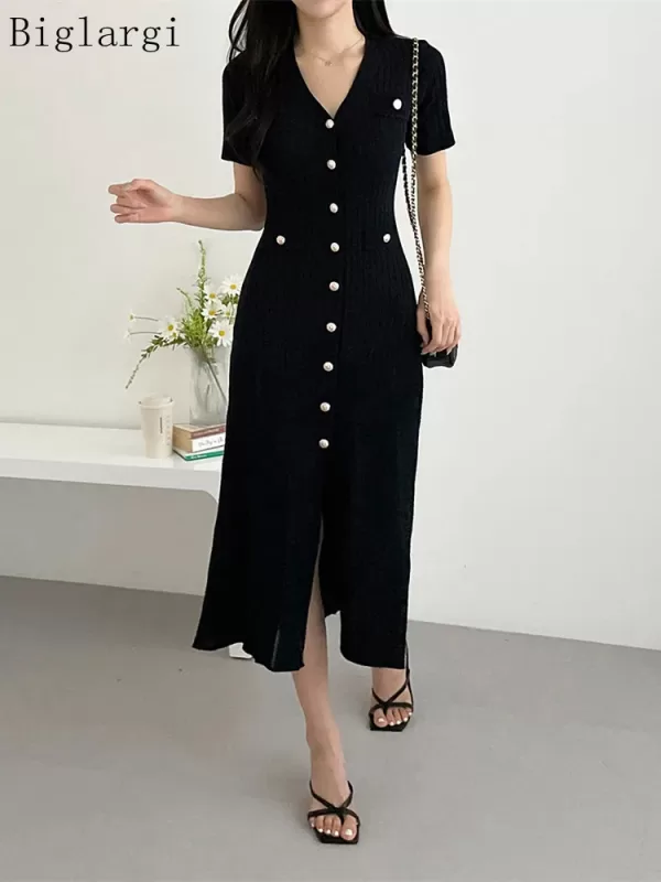 A black knitted midi dress styled with sandals, creating a perfect summer outfit.