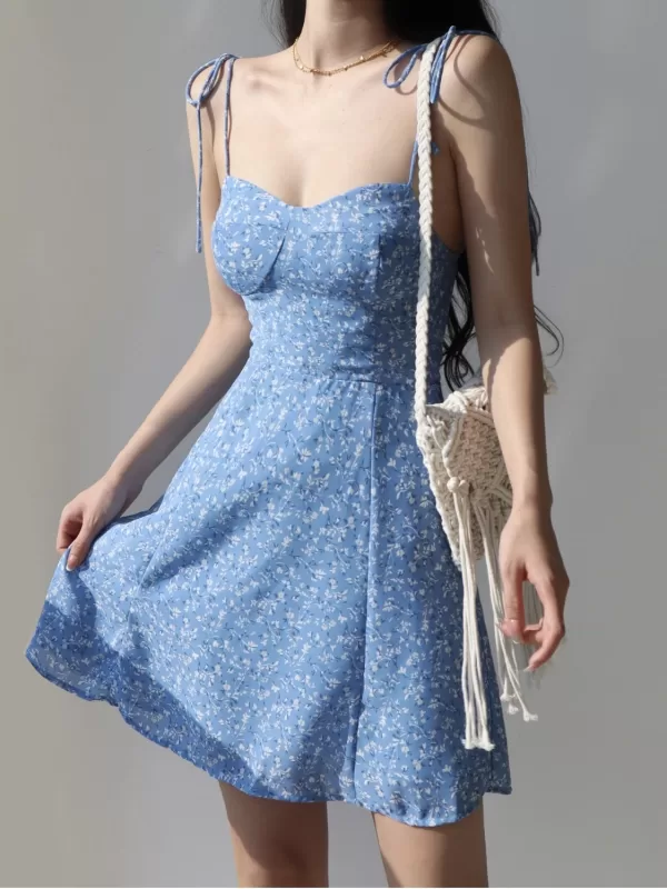 Smiling girl twirling in a vintage spaghetti strap Korean dress.