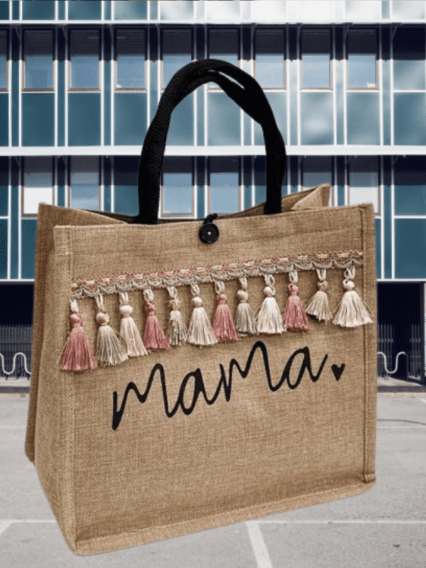 Person holding a reusable cloth shopping tote bag filled with fresh fruits and vegetables.