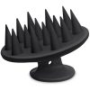 Black silicone scalp massager brush with pointed bristles.