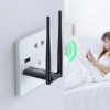 Black USB WiFi repeater signal booster plugged into laptop