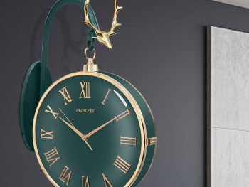 Stylish green wall clock with gold Roman numerals and a deer antler accent.