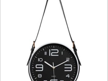 Stylish black and white industrial wall clock with a minimalist design and leather strap.