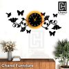Close-up of intricate 3D butterfly and bird carvings on a wooden wall clock, showcasing fine craftsmanship.