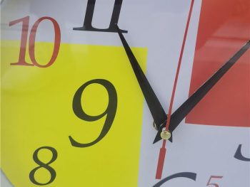 Close-up view of the colorful face of a modern digital wall clock.