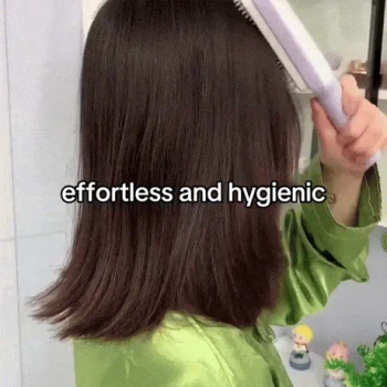 Close up of one-pull clean mechanism removing hair from a self cleaning brush