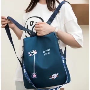 A woman wearing a stylish backpack in a trendy design, perfect for school or everyday use.