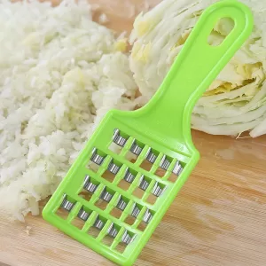 Close-up shot of a multifunction cabbage filling cutter with shredded cabbage in the container