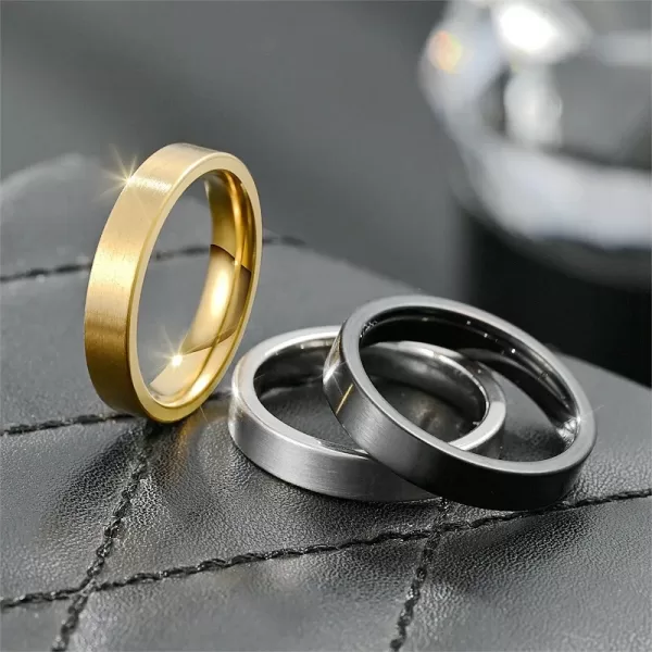 Close-up view of a pair of Women's Stainless Steel Couple Rings. The image showcases the smooth, polished finish and simple design.