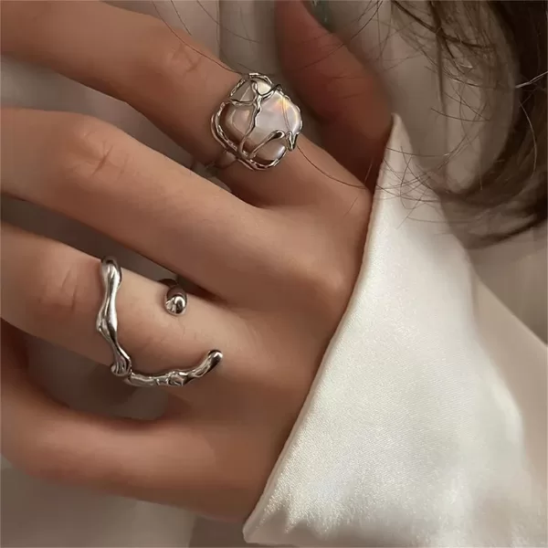 A close-up photo showcasing multiple Twined Finger Rings for women in different styles and finishes