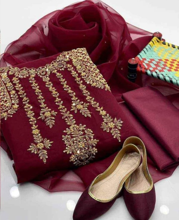 A luxurious 4-piece outfit featuring organza fabric adorned with intricate zari beadwork. Includes a qattan silk trouser and khussa shoes. Perfect for festive occasions.