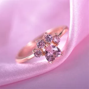 Close-up photo of a silver Cat Paw Engagement Ring featuring a sparkling central crystal and a cute paw design with pink accents (if applicable).