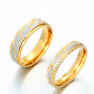 A close-up photo of two gold wedding rings, one for him and one for her, lying side-by-side. Both rings have a polished finish and a beautiful wave pattern