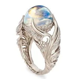 Close-up photo of the silver angel wing moonstone ring, showcasing the detailed wings and shimmering stone.