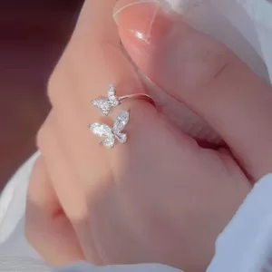 Close-up photo of a silver butterfly ring with clear cubic zirconia