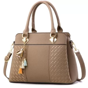 Stylish light brown handbag with a gold chain strap and tassel, ideal for everyday wear.