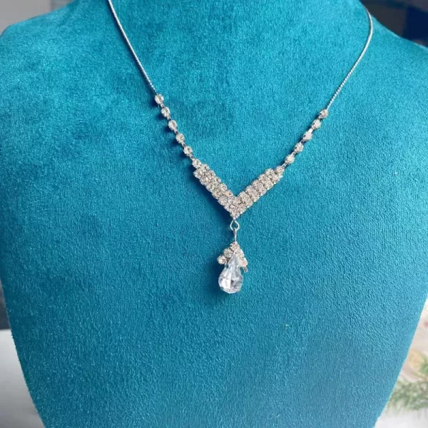 Diamond Wite gemstone necklace adding a touch of elegance to a woman's outfit.