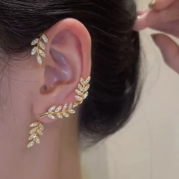 Close-up view of silver plated earrings, showcasing the shimmering metal leaf design.