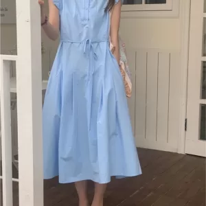 miling girl wearing a flowing summer long dress with ruffles, Korean fashion style 2024.