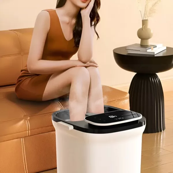 Person relaxing with feet in a heated footbath with massaging bubbles