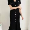 A flattering black knitted midi dress with a bodycon silhouette, perfect for summer.
