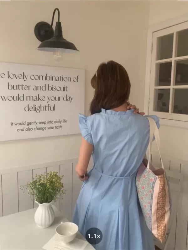 Girl twirling in a long summer dress with ruffles, showcasing Korean fashion for girls in 2024.