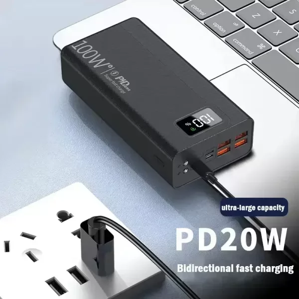 Black portable power bank with a smartphone connected to one of its USB ports.