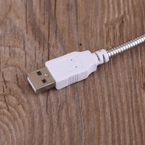 Close-up shot of the black USB plug connected to the base of the USB desktop fan.