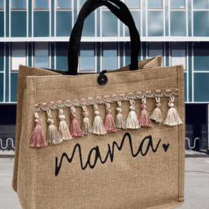 Person holding a reusable cloth shopping tote bag filled with fresh fruits and vegetables.