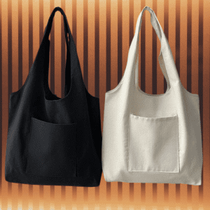 Person carrying a reusable canvas tote bag filled with groceries on a sunny day.