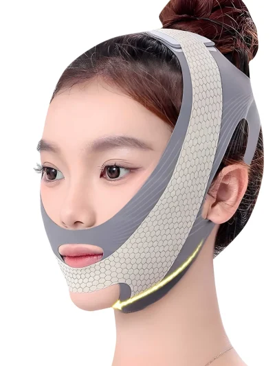 A woman wearing a grey V-line face slimming belt with off-white honeycomb pattern mesh along the jawline, featuring precise cutouts for the nose, mouth, and ears.