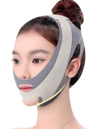 A woman wearing a grey V-line face slimming belt with off-white honeycomb pattern mesh along the jawline, featuring precise cutouts for the nose, mouth, and ears.