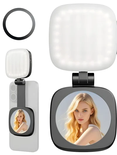 A square illuminated LED fill light with side control buttons attached to a black hinge mount with a built-in circular selfie mirror shown mounted on a smartphone, along with a separate black magnetic ring.