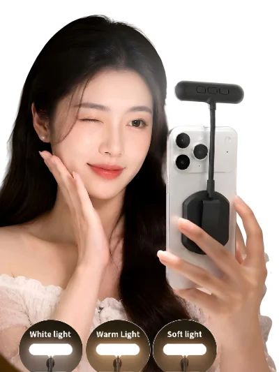 A woman posing next to a smartphone with a black RK-14F magnetic fill light attached to the back, alongside three circular icons illustrating White light, Warm Light, and Soft light modes.