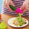 Spiral vegetable slicer in use Creating vegetable noodles with a kitchen tool Slicing cucumber into spirals