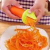 Spiralizing carrots with a handheld slicer Making carrot noodles Vegetable spiralizer in use