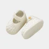 Infant wearing soft knit shoes baby girl prewalker on an indoor floor (1).