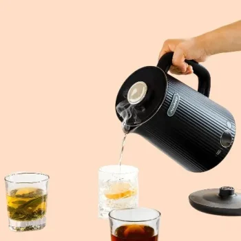 Black electric kettle with LED temperature control on a modern kitchen counter, showing stainless steel interior (1).