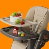 Baby sitting in a raised foldable dining chair at the table (2).