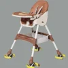 Baby dinig chair sittin in a foldable high chair during mealtime at home (1).