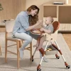 Baby dinig chair sittin in a foldable high chair during mealtime at home (2).
