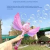 Child playing with a Frozen-themed automatic bubble wand outdoors on a sunny day (2).