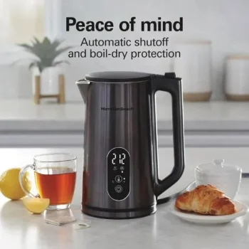 Hamilton Beach digital electric tea kettle with 5 presets and steam rising, placed on a modern kitchen counter (2).