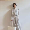 Woman wearing Korean-style wide-leg drape trousers outdoors (1).