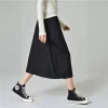 Woman wearing a Korean pleated workwear skirt with drawstring waist and side pockets (1).