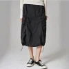 Woman wearing a Korean pleated workwear skirt with drawstring waist and side pockets (3).